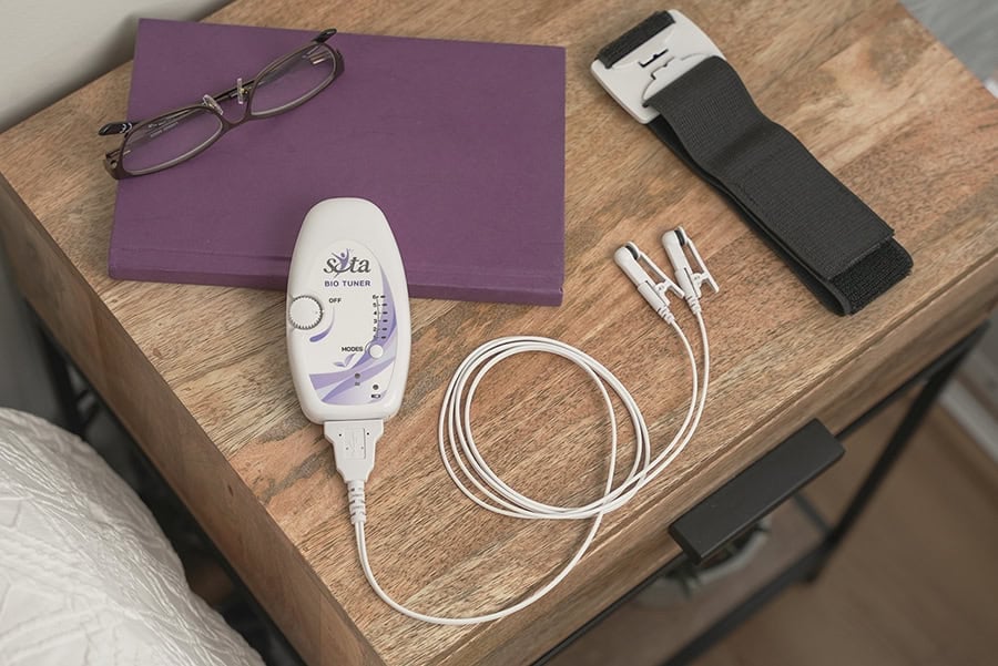 SOTA Bio Tuner and accessories on a bedside table